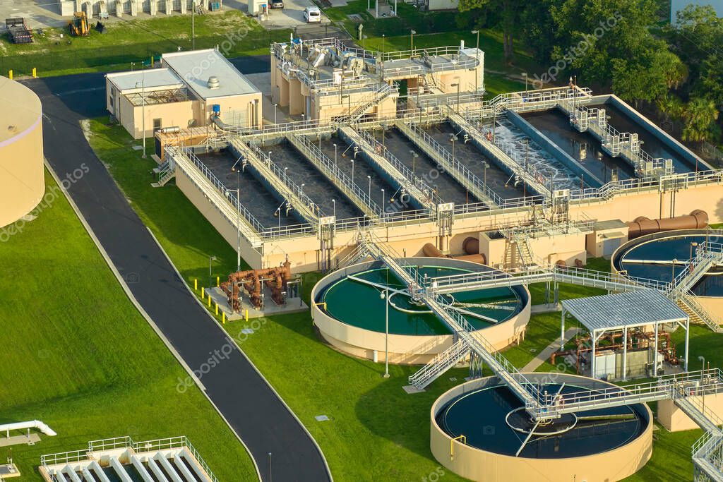 Aerial view of modern water cleaning facility at urban wastewater treatment plant. Purification