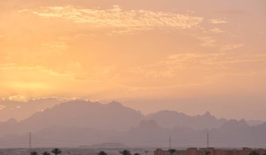 Sunset landscape with dark mountain peaks in egyptian desert.