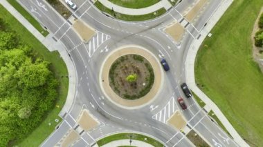 Aerial view of road roundabout intersection with moving cars traffic. Rural circular transportation crossroads.