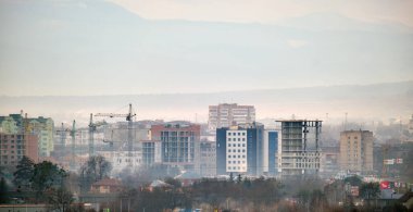 Yüksek konutlu apartman şantiyesindeki vinçler. Gayrimenkul geliştirme.