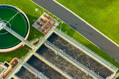 Aerial view of modern water cleaning facility at urban wastewater treatment plant. Purification process of removing undesirable chemicals, suspended solids and gases from contaminated liquid.