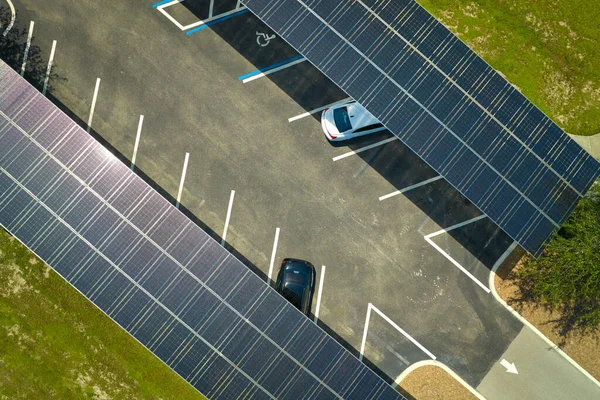 Solar panels installed over parking lot for parked cars for effective generation of clean energy.