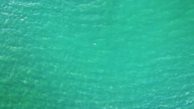 Aerial view of seascape surface of green sea water with small ripple waves.