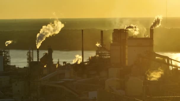 工場製造場の製造工程で発生する二酸化炭素煙で大気中を汚染する煙突の高い巨大な工場 日没時の工業用地 — ストック動画