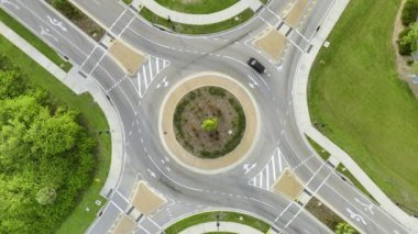 Aerial view of road roundabout intersection with moving cars traffic. Rural circular transportation crossroads.
