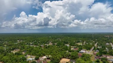 Aerial landscape view of suburban private houses between green palm trees in Florida quiet rural area.