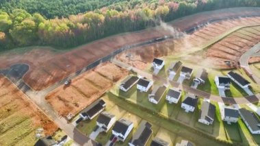 Real estate development with tightly located family houses under construction in South Carolina suburban area. Concept of growing american suburbs.