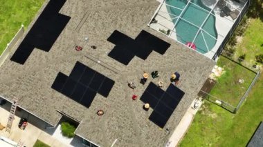 Aerial view of solar panels installation on typical american house roof for producing clean ecological electric energy. Renewable electricity with zero emission concept.
