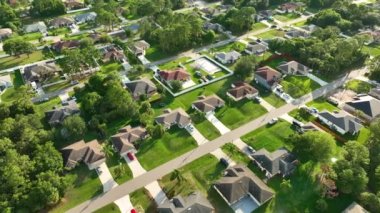 Aerial landscape view of suburban private houses between green palm trees in Florida quiet rural area.