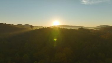 Aerial view of high hills in Appalachian mountains with yellow woods in fall season. Amazing scenery of wild american mountain woodland.
