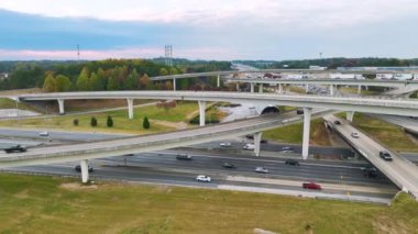 Aerial view of american freeway intersection with fast moving cars and trucks. USA transportation infrastructure concept. Atlanta, USA - November 14, 2022.