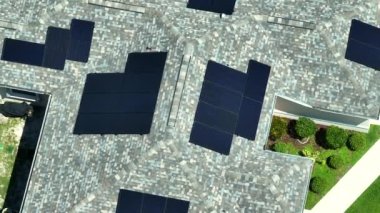 Standard american residential house with rooftop covered with solar photovoltaic panels for producing of clean electrical energy in suburban rural area. Concept of investment in autonomous home.