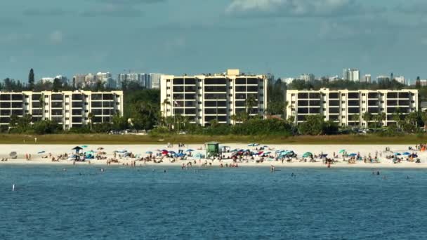 アメリカのサラソータにあるシエスタキー砂浜の空中風景 多くの観光客は 暖かいメキシコ湾の水と暑いフロリダの太陽の下で日光浴で夏休みの時間を楽しむ — ストック動画
