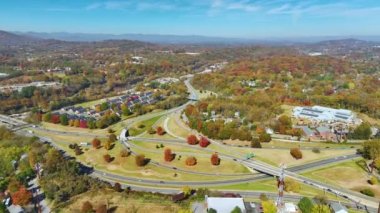 American freeway intersection in Asheville, North Carolina with fast driving cars and trucks in autumnal season. View from above of USA transportation infrastructure.