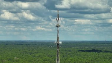 Tall telecommunication radio cell tower with wireless communication 5g antennas for network signal transmission.