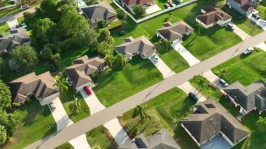 Aerial landscape view of suburban private houses between green palm trees in Florida quiet rural area.