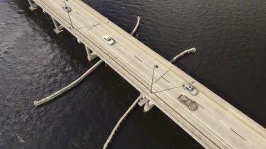 Aerial view of Barron Collier Bridge and Gilchrist Bridge in Florida with moving traffic. Transportation infrastructure in Charlotte County connecting Punta Gorda and Port Charlotte over Peace River.
