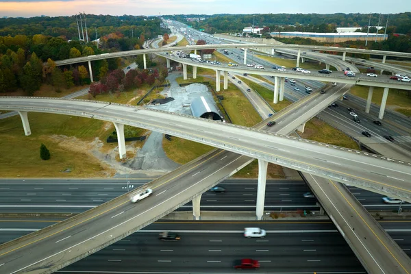 Aerial view of american freeway intersection with fast moving cars and trucks. USA transportation infrastructure concept.
