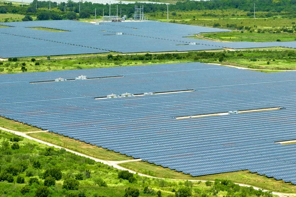 stock image Aerial view of big sustainable electric power plant with many rows of solar photovoltaic panels for producing clean electrical energy. Renewable electricity with zero emission concept.