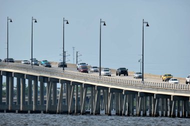 Barron Collier Bridge and Gilchrist Bridge in Florida with moving traffic. Transportation infrastructure in Charlotte County connecting Punta Gorda and Port Charlotte over Peace River.