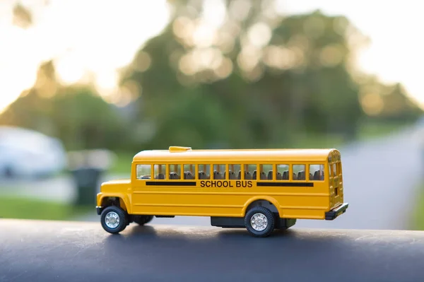 Little model of american yellow school bus outdoor. Concept of education safety in the USA.