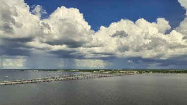 Aerial view of Barron Collier Bridge and Gilchrist Bridge in Florida with moving traffic. Transportation infrastructure in Charlotte County connecting Punta Gorda and Port Charlotte over Peace River.