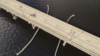 Aerial view of Barron Collier Bridge and Gilchrist Bridge in Florida with moving traffic. Transportation infrastructure in Charlotte County connecting Punta Gorda and Port Charlotte over Peace River.