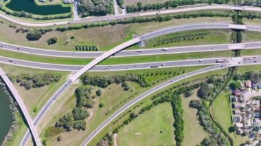 Aerial view of freeway overpass junction with fast moving traffic cars and trucks in american rural area. Interstate transportation infrastructure in USA.