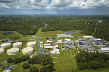 Aerial view of modern water cleaning facility at urban wastewater treatment plant. Purification process of removing undesirable chemicals, suspended solids and gases from contaminated liquid.