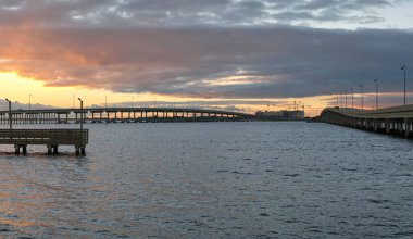 Barron Collier Bridge and Gilchrist Bridge in Florida with moving traffic. Transportation infrastructure in Charlotte County connecting Punta Gorda and Port Charlotte over Peace River.