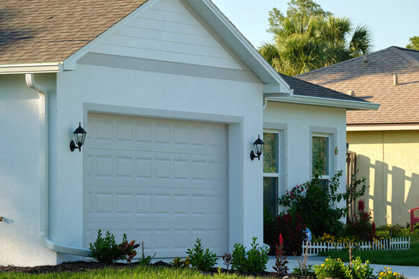Wide garage double door and concrete driveway of new modern american house.