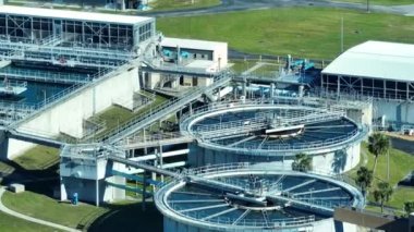 Aerial view of modern water cleaning facility at urban wastewater treatment plant. Purification process of removing undesirable chemicals, suspended solids and gases from contaminated liquid.