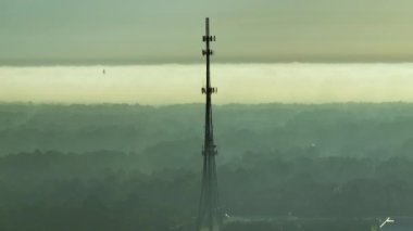 Tall telecommunication radio cell tower with wireless communication 5g antennas for network signal transmission.
