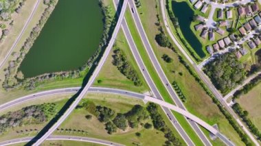 Elevated view of freeway exit junction over road lanes with fast moving traffic cars and trucks. Interstate transportation infrastructure in USA.