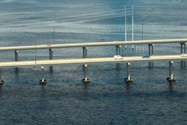 Barron Collier Bridge and Gilchrist Bridge in Florida with moving traffic. Transportation infrastructure in Charlotte County connecting Punta Gorda and Port Charlotte over Peace River.