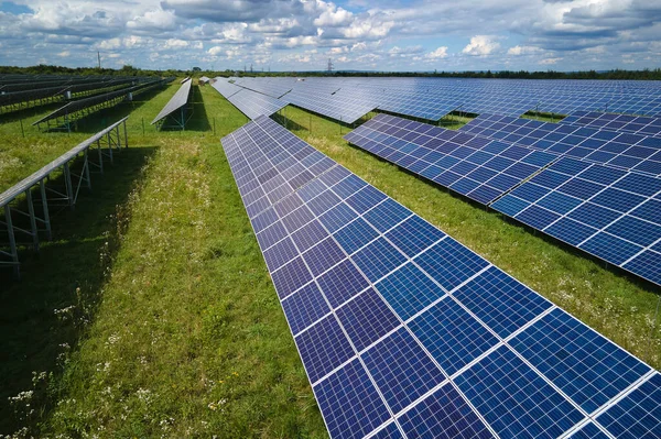 stock image Aerial view of large sustainable electrical power plant with rows of solar photovoltaic panels for producing clean electric energy. Concept of renewable electricity with zero emission.