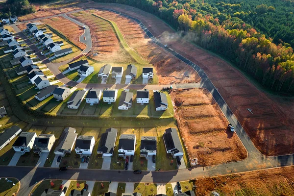 Aerial view of real estate development with tightly located family houses under construction in Carolinas suburban area. Concept of growing american suburbs.