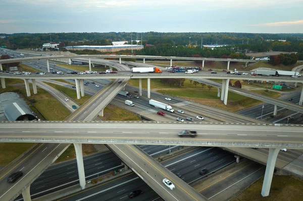 stock image American freeway intersection with fast driving cars and trucks. View from above of USA transportation infrastructure.