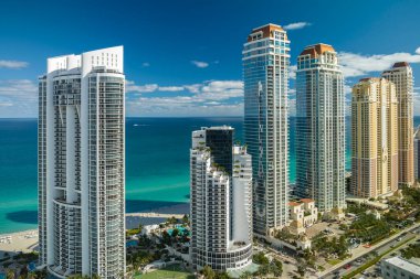 Sunny Isles Beach City 'deki Atlantik Okyanusu kıyısındaki lüks otellerin ve apartmanların manzarası. Güney Florida 'daki Amerikan turizm altyapısı.