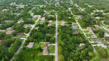 Aerial landscape view of suburban private houses between green palm trees in Florida quiet rural area.