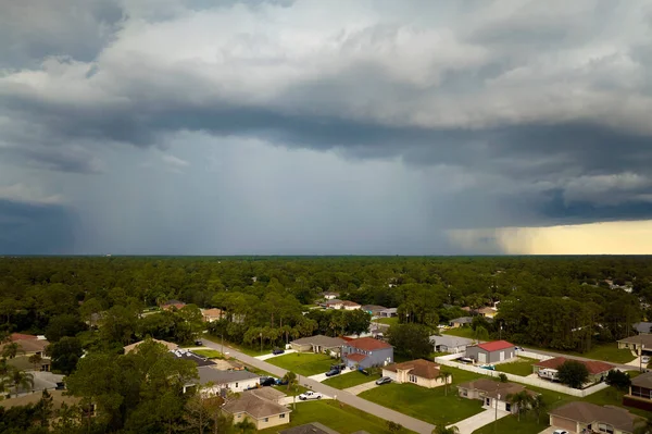 stock image Dark stormy clouds forming on gloomy sky during heavy rainfall season over suburban town area.