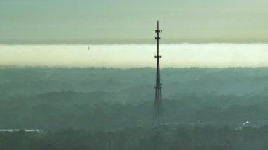 Aerial view of telecommunications cell phone tower with wireless communication 5g antennas for network signal transmission.