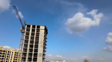 Tower lifting cranes at high residential apartment buildings construction site. Real estate development.