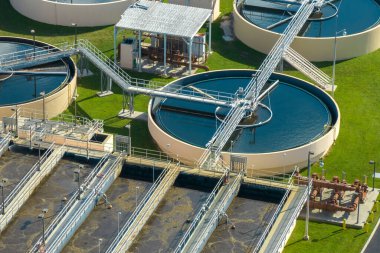 Aerial view of modern water cleaning facility at urban wastewater treatment plant. Purification process of removing undesirable chemicals, suspended solids and gases from contaminated liquid.