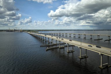 Barron Collier Bridge and Gilchrist Bridge in Florida with moving traffic. Transportation infrastructure in Charlotte County connecting Punta Gorda and Port Charlotte over Peace River.