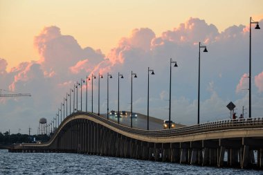 Barron Collier Bridge and Gilchrist Bridge in Florida with moving traffic. Transportation infrastructure in Charlotte County connecting Punta Gorda and Port Charlotte over Peace River.