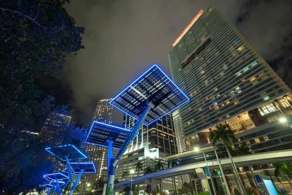 stock image Blue solar photovoltaic panels mounted in modern city on street poles for electricity supply of streetlights and surveillance cameras. Futuristic energy source in downtown Miami, Florida.