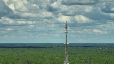 Aerial view of telecommunications cell phone tower with wireless communication 5g antennas for network signal transmission.