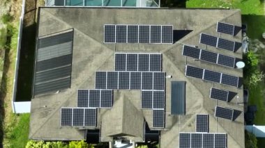 Aerial view of typical american building roof with rows of blue solar photovoltaic panels for producing clean ecological electric energy. Renewable electricity with zero emission concept.