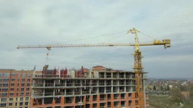 Tower cranes and frame structure of high residential apartment buildings at construction site. Real estate development.